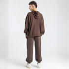 Model wearing the BROWNTOAST Core Cuffed Sweats from the Core Drop in coffee brown — unisex cotton sweatpants with cuffed ankles, adjustable drawstring waist, and side pockets. Made in Egypt for a relaxed, structured, and effortless everyday fit.