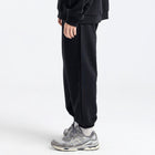 Model wearing the BROWNTOAST Core Cuffed Sweats from the Core Drop in black — unisex cotton sweatpants with cuffed ankles, adjustable drawstring waist, and side pockets. Made in Egypt for a relaxed, structured, and effortless everyday fit.