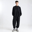 Model wearing the BROWNTOAST Core Cuffed Sweats from the Core Drop in black — unisex cotton sweatpants with cuffed ankles, adjustable drawstring waist, and side pockets. Made in Egypt for a relaxed, structured, and effortless everyday fit.