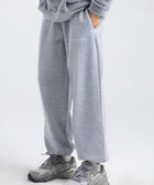 Model wearing the BROWNTOAST Core Cuffed Sweats from the Core Drop in light grey — unisex cotton sweatpants with cuffed ankles, adjustable drawstring waist, and side pockets. Made in Egypt for a relaxed, structured, and effortless everyday fit.