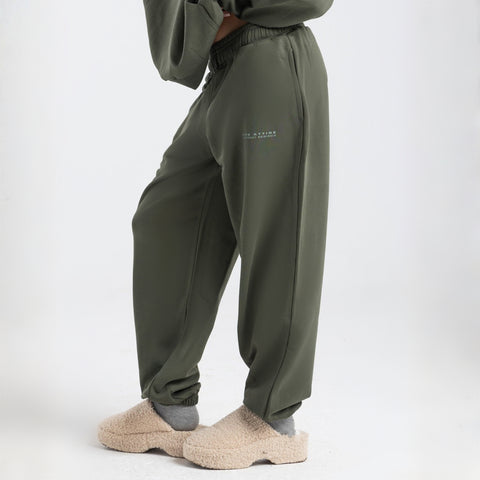 Model wearing the BROWNTOAST Core Cuffed Sweats from the Core Drop in olive green — unisex cotton sweatpants with cuffed ankles, adjustable drawstring waist, and side pockets. Made in Egypt for a relaxed, structured, and effortless everyday fit.
