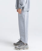 Model wearing the BROWNTOAST Core Cuffed Sweats from the Core Drop in light grey — unisex cotton sweatpants with cuffed ankles, adjustable drawstring waist, and side pockets. Made in Egypt for a relaxed, structured, and effortless everyday fit.