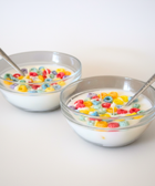 BROWNTOAST Cereal Candle — realistic handcrafted fruity-scented candle designed to look like a bowl of cereal. Comes in a reusable glass bowl with a metal spoon. Part of the Dopamine Decor lifestyle drop.