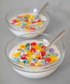BROWNTOAST Cereal Candle — realistic handcrafted fruity-scented candle designed to look like a bowl of cereal. Comes in a reusable glass bowl with a metal spoon. Part of the Dopamine Decor lifestyle drop.