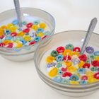 BROWNTOAST Cereal Candle — realistic handcrafted fruity-scented candle designed to look like a bowl of cereal. Comes in a reusable glass bowl with a metal spoon. Part of the Dopamine Decor lifestyle drop.