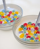 BROWNTOAST Cereal Candle — realistic handcrafted fruity-scented candle designed to look like a bowl of cereal. Comes in a reusable glass bowl with a metal spoon. Part of the Dopamine Decor lifestyle drop.