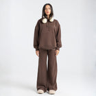 Model wearing the BROWNTOAST Core Flared Sweats from the Core Drop — women’s cotton-lycra flared sweatpants with a mid-rise waist, adjustable drawstring, and subtle seam detailing. Made in Egypt for a soft, flattering, and effortless everyday look. In coffee brown color.