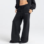 Model wearing the BROWNTOAST Core Flared Sweats from the Core Drop — women’s cotton-lycra flared sweatpants with a mid-rise waist, adjustable drawstring, and subtle seam detailing. Made in Egypt for a soft, flattering, and effortless everyday look. In black color.