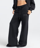 Model wearing the BROWNTOAST Core Flared Sweats from the Core Drop — women’s cotton-lycra flared sweatpants with a mid-rise waist, adjustable drawstring, and subtle seam detailing. Made in Egypt for a soft, flattering, and effortless everyday look. In black color.