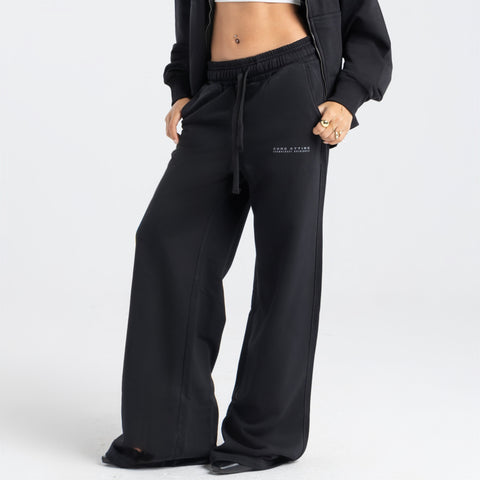 Model wearing the BROWNTOAST Core Flared Sweats from the Core Drop — women’s cotton-lycra flared sweatpants with a mid-rise waist, adjustable drawstring, and subtle seam detailing. Made in Egypt for a soft, flattering, and effortless everyday look. In black color.