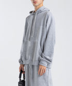 Model wearing the BROWNTOAST Core Hoodie from the Core Drop in light grey— a relaxed unisex hoodie with an adjustable drawstring hood, kangaroo pocket, and front silk-screen print. Made in Egypt from a soft cotton blend for an elevated everyday look.