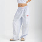 Unisex wide-leg striped cotton pants in ocean blue and white, relaxed slouchy fit, modeled with casual summer outfit.