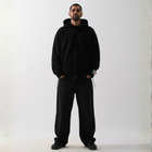 Model wearing the BROWNTOAST Anonymous Attire Polar Fleece Masked Hoodie — unisex fleece hoodie with full-zip masked hood, drop shoulders, patch detailing, and adjustable side clasps. Made in Egypt from 100% polar fleece for warmth and street-ready edge.