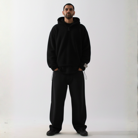 Model wearing the BROWNTOAST Anonymous Attire Polar Fleece Masked Hoodie — unisex fleece hoodie with full-zip masked hood, drop shoulders, patch detailing, and adjustable side clasps. Made in Egypt from 100% polar fleece for warmth and street-ready edge.