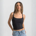 Black ribbed spaghetti tank styled with denim jeans for a casual everyday outfit.