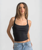 Black ribbed spaghetti tank styled with denim jeans for a casual everyday outfit.