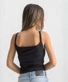 Black ribbed spaghetti tank styled with denim jeans for a casual everyday outfit.
