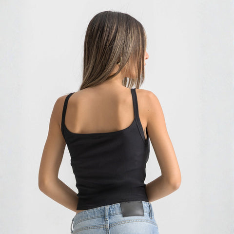 Black ribbed spaghetti tank styled with denim jeans for a casual everyday outfit.