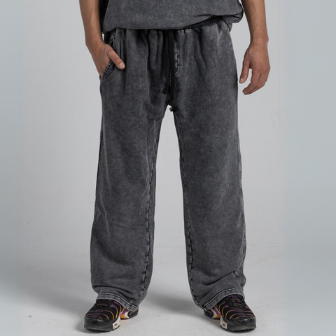Model wearing the BROWNTOAST ASSID Men’s Straight-Leg Sweatpants from the ASSID Kollection — relaxed-fit cotton-blend sweatpants with straight-leg cut, adjustable waist, and unique dye variations. Made in Egypt for a timeless, effortless streetwear look.