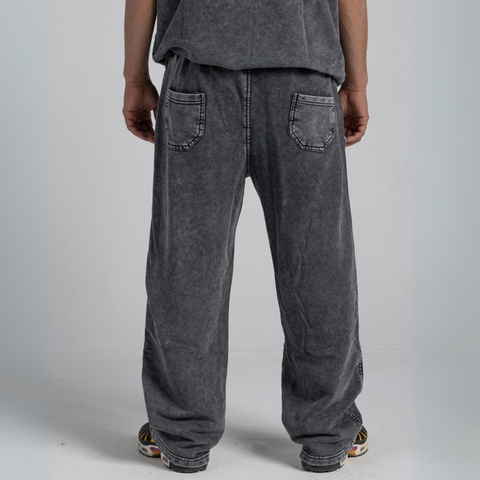 Model wearing the BROWNTOAST ASSID Men’s Straight-Leg Sweatpants from the ASSID Kollection — relaxed-fit cotton-blend sweatpants with straight-leg cut, adjustable waist, and unique dye variations. Made in Egypt for a timeless, effortless streetwear look.