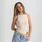 beige ribbed basic tank top for women, front view showcasing fitted silhouette and minimal design.