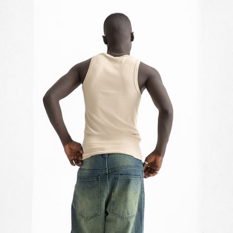 Men’s beige ribbed tank top, back view showcasing fitted silhouette and minimal design