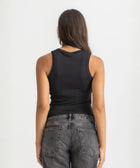 Black ribbed basic tank top for women, back view showcasing fitted silhouette and minimal design.