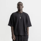 Men’s black box-fit oversized tee, front view showcasing relaxed fit and minimalist design.