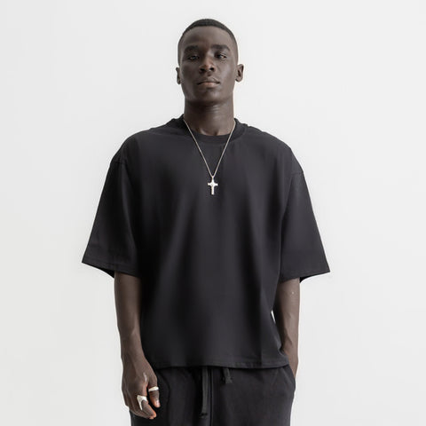 Men’s black box-fit oversized tee, front view showcasing relaxed fit and minimalist design.