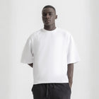 Men’s white box-fit oversized tee, front view showcasing relaxed fit and minimalist design.