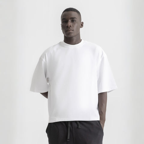 Men’s white box-fit oversized tee, front view showcasing relaxed fit and minimalist design.