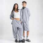 Model wearing the BROWNTOAST Core Barrel Sweats from the Core Drop — unisex cotton sweatpants in light grey with a relaxed barrel-shaped leg, elastic waistband, and side pockets. Made in Egypt for structured comfort and clean everyday style.