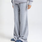 Model wearing the BROWNTOAST Core Flared Sweats from the Core Drop — women’s cotton-lycra flared sweatpants with a mid-rise waist, adjustable drawstring, and subtle seam detailing. Made in Egypt for a soft, flattering, and effortless everyday look. In light grey color.