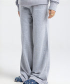 Model wearing the BROWNTOAST Core Flared Sweats from the Core Drop — women’s cotton-lycra flared sweatpants with a mid-rise waist, adjustable drawstring, and subtle seam detailing. Made in Egypt for a soft, flattering, and effortless everyday look. In light grey color.