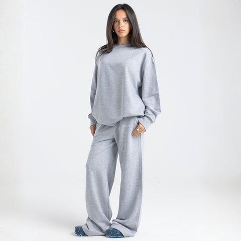 Model wearing the BROWNTOAST Core Flared Sweats from the Core Drop — women’s cotton-lycra flared sweatpants with a mid-rise waist, adjustable drawstring, and subtle seam detailing. Made in Egypt for a soft, flattering, and effortless everyday look. In light grey color.