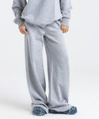 Model wearing the BROWNTOAST Core Flared Sweats from the Core Drop — women’s cotton-lycra flared sweatpants with a mid-rise waist, adjustable drawstring, and subtle seam detailing. Made in Egypt for a soft, flattering, and effortless everyday look. In light grey color.