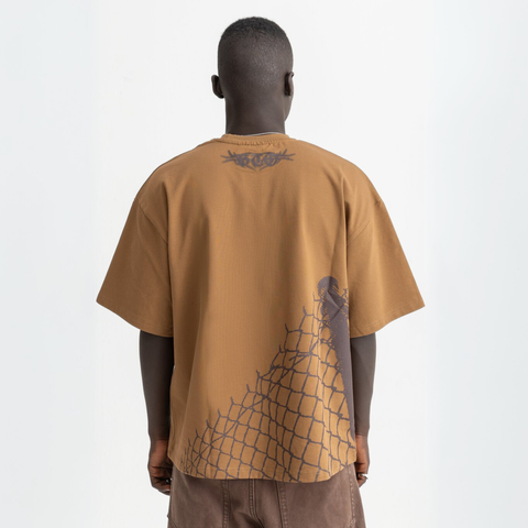 Back view of burnt brown cotton t-shirt featuring broken chain-link fence print.