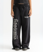 Unisex black baggy sweatpants with chunky waistband, raw pocket detailing, and light grey grunge print.