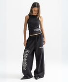 Unisex black baggy sweatpants with chunky waistband, raw pocket detailing, and light grey grunge print.