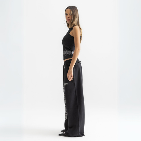 Unisex black baggy sweatpants with chunky waistband, raw pocket detailing, and light grey grunge print.