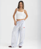 Unisex wide-leg striped cotton pants in ocean blue and white, relaxed slouchy fit, modeled with casual summer outfit.