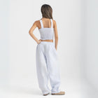 Unisex wide-leg striped cotton pants in ocean blue and white, relaxed slouchy fit, modeled with casual summer outfit.