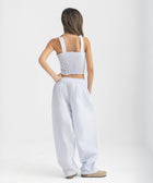Unisex wide-leg striped cotton pants in ocean blue and white, relaxed slouchy fit, modeled with casual summer outfit.