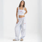 Unisex wide-leg striped cotton pants in ocean blue and white, relaxed slouchy fit, modeled with casual summer outfit.