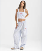 Unisex wide-leg striped cotton pants in ocean blue and white, relaxed slouchy fit, modeled with casual summer outfit.