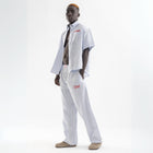 Unisex wide-leg striped cotton pants in ocean blue and white, relaxed slouchy fit, modeled with casual summer outfit.