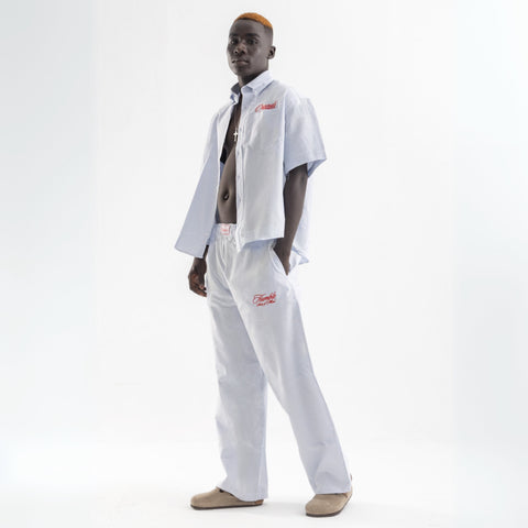 Unisex wide-leg striped cotton pants in ocean blue and white, relaxed slouchy fit, modeled with casual summer outfit.