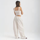 Unisex wide-leg striped cotton pants in beige and white, relaxed slouchy fit, modeled with casual summer outfit.