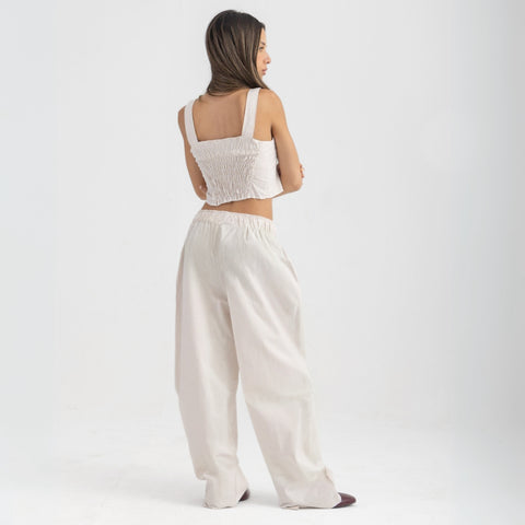 Unisex wide-leg striped cotton pants in beige and white, relaxed slouchy fit, modeled with casual summer outfit.