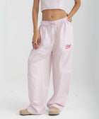 Unisex wide-leg striped cotton pants in pink and white, relaxed slouchy fit, modeled with casual summer outfit.